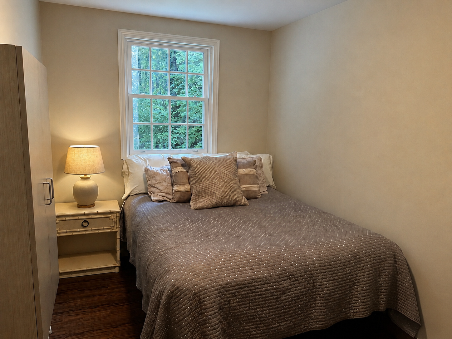Second guesthouse bedroom with a window overlooking the trees