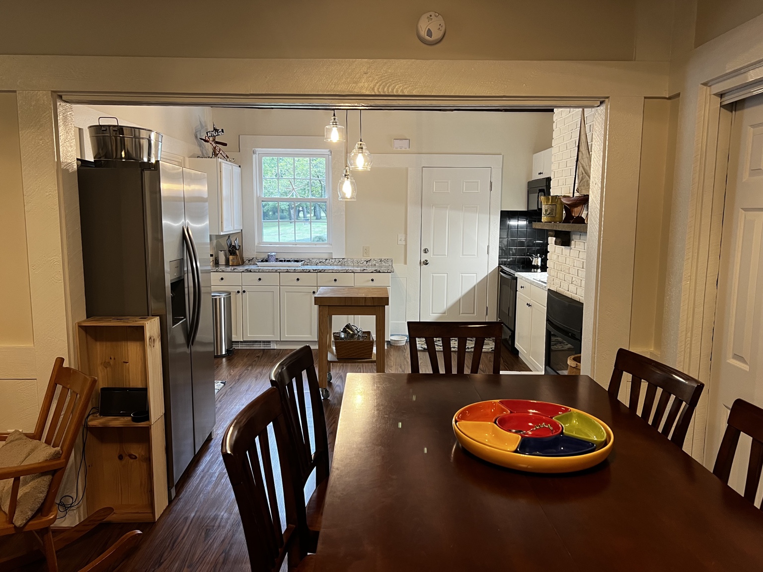 Dining table opening into the full kitchen