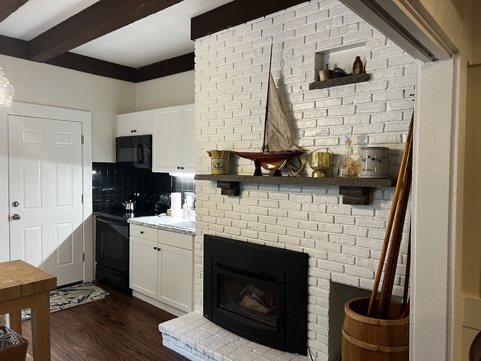 White-brick fireplace feature beside the guesthouse kitchen