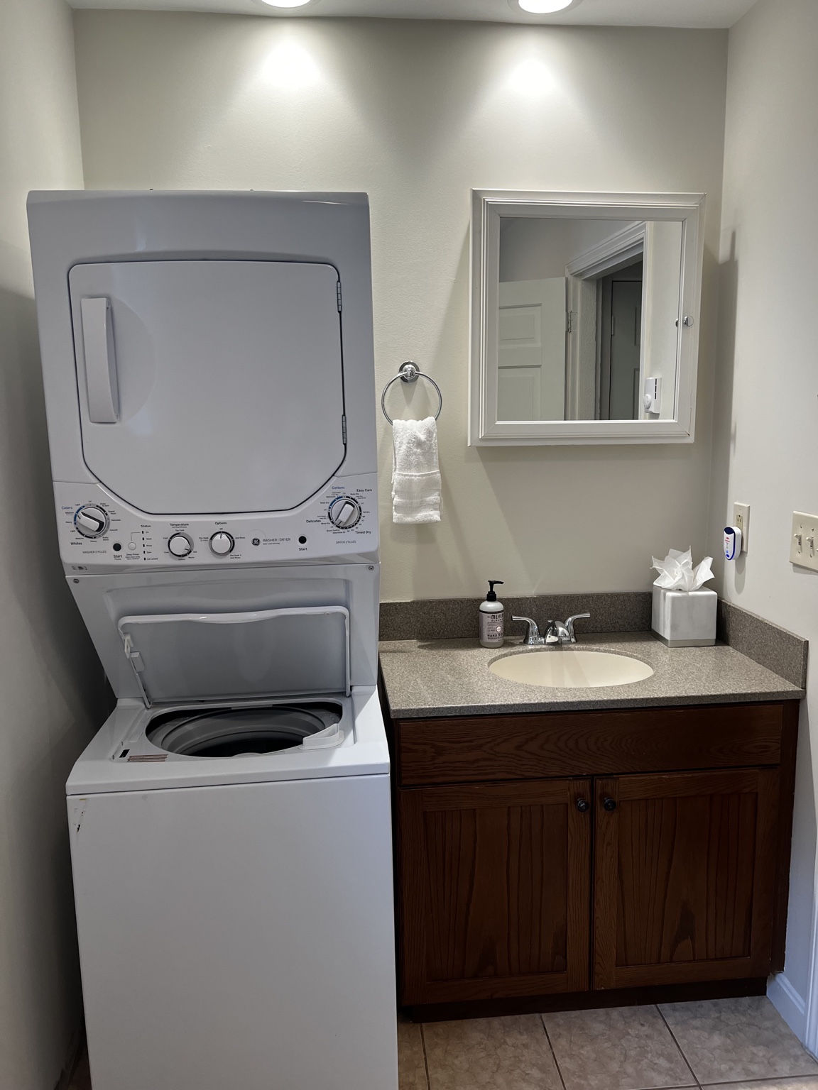 In-unit washer and dryer beside the bathroom vanity